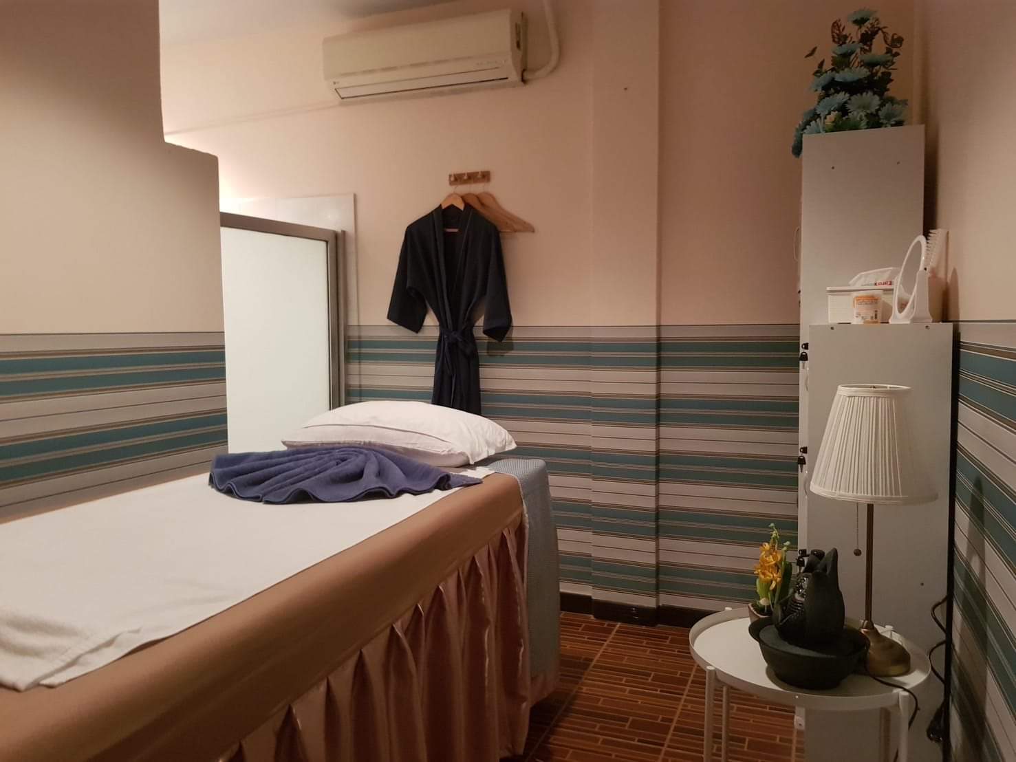 VIP massage room with private robe and massage bed at Cher Ploy
